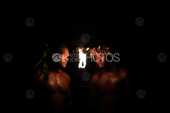 BORA BORA, PORTRAIT OF POLYNESIAN MEN WITH FIRE TORCH AT NIGHT